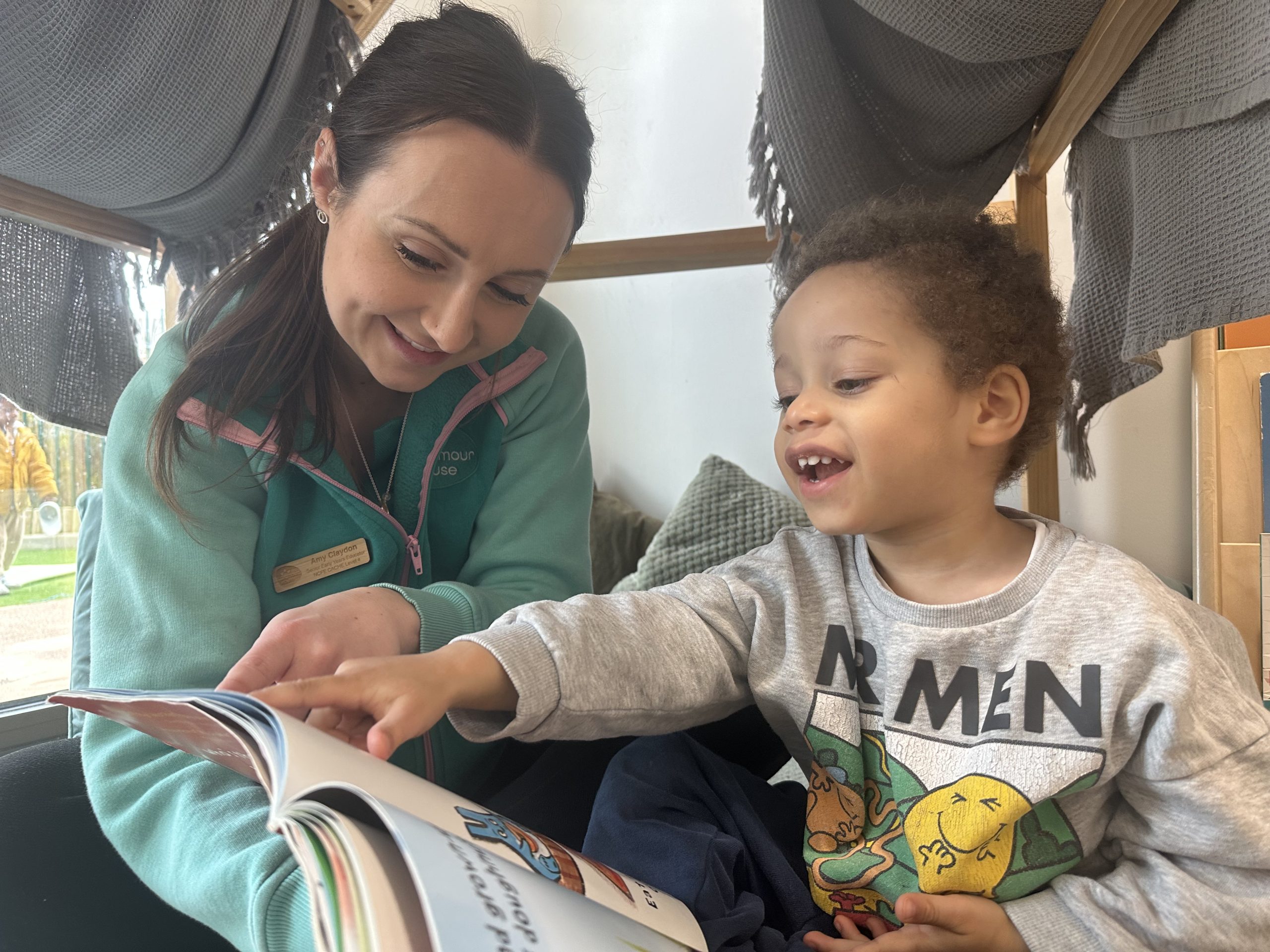 A photo showing a Seymour House member of staff with a nursery child.